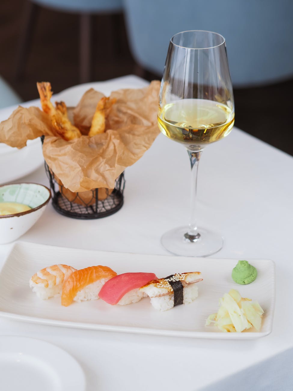 sushi fried chips with dip and glass of white wine at restaurant