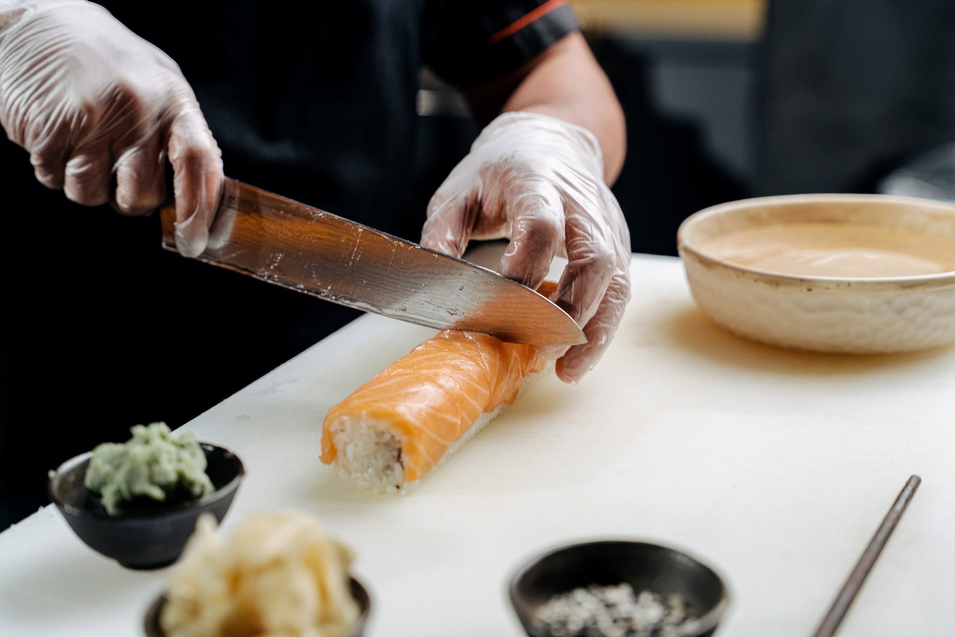 a person cutting sushi